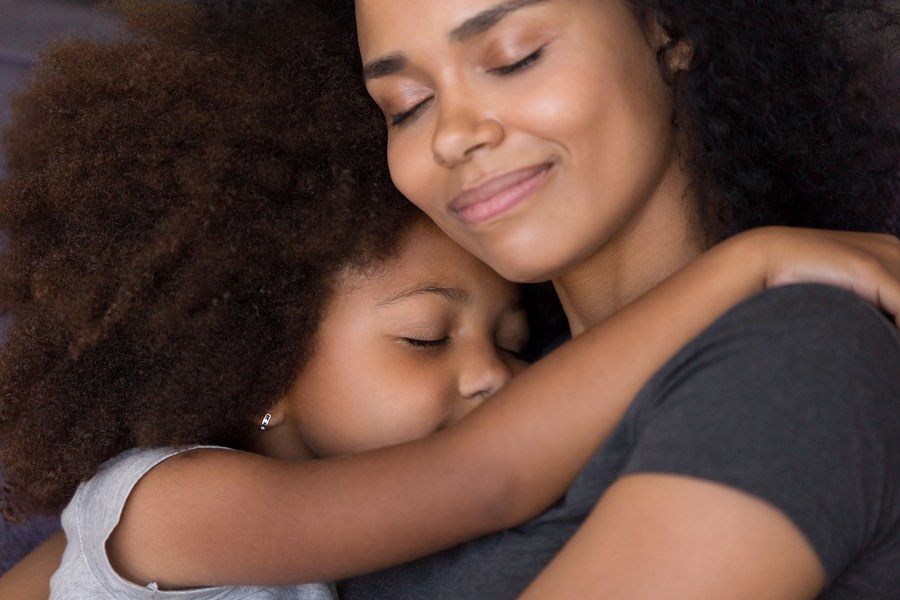 Loving Single Black Mother Hugs Cute Daughter Feel Tenderness Connection