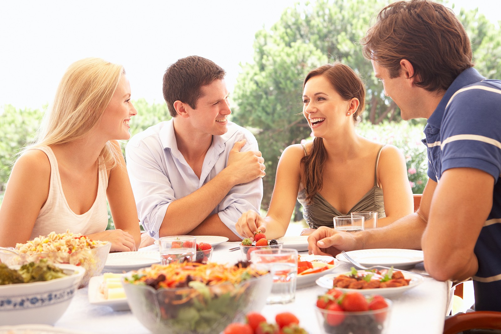Two young couples eating outdoors