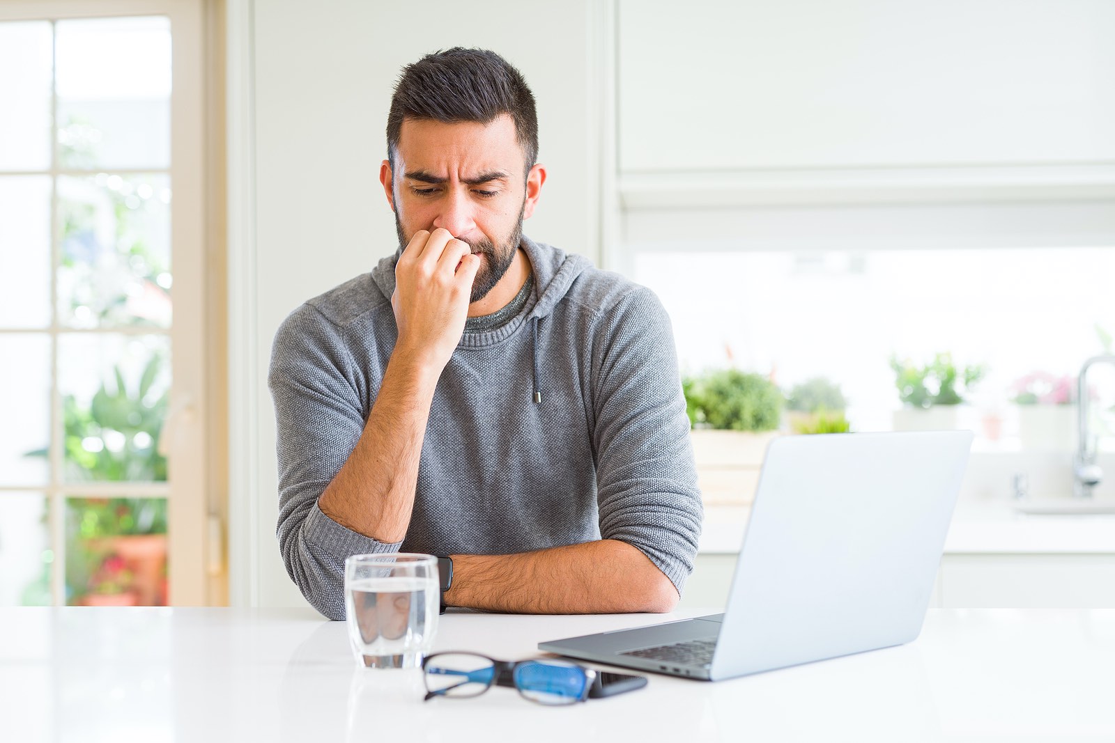Man stressed and depressed sitting at table